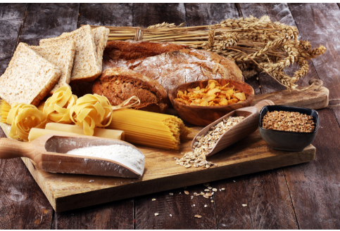 Photo of rustic breads, wheat, pasta, and other ingredients containing gluten